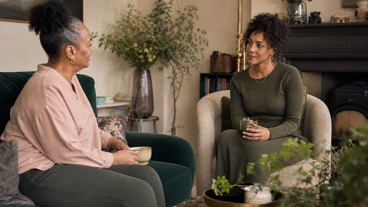 Two Black British women from different generations sharing a conversation at home